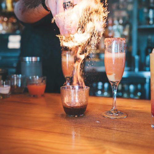 bartender-lighting-cocktail-on-fire_t20_rOQKlB